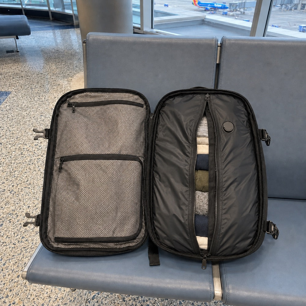 The carry-on open on an airport seat, packed for a week
