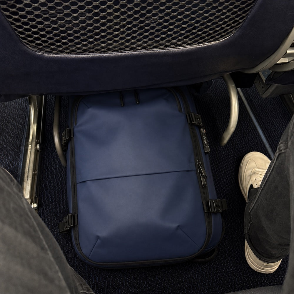 The carry-on stowed under an airplane seat